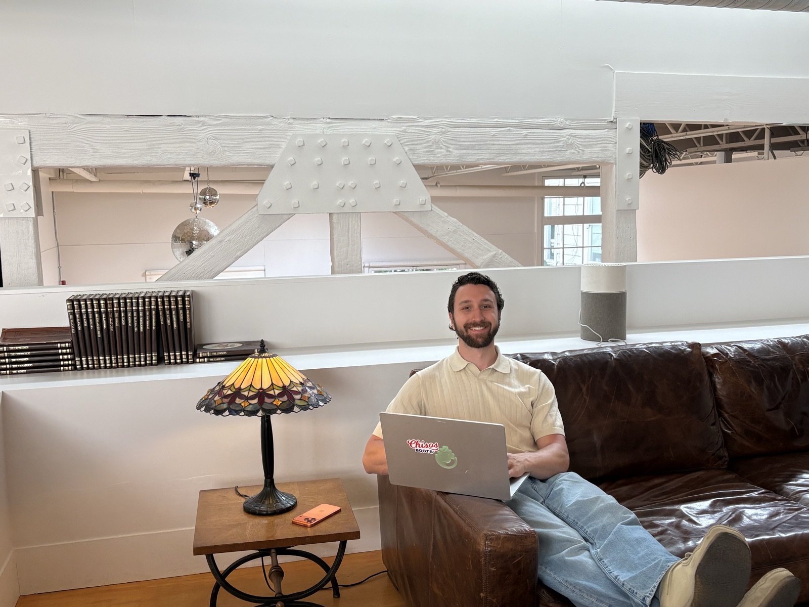 Blaise Hylak working on a couch in the Raindrop office