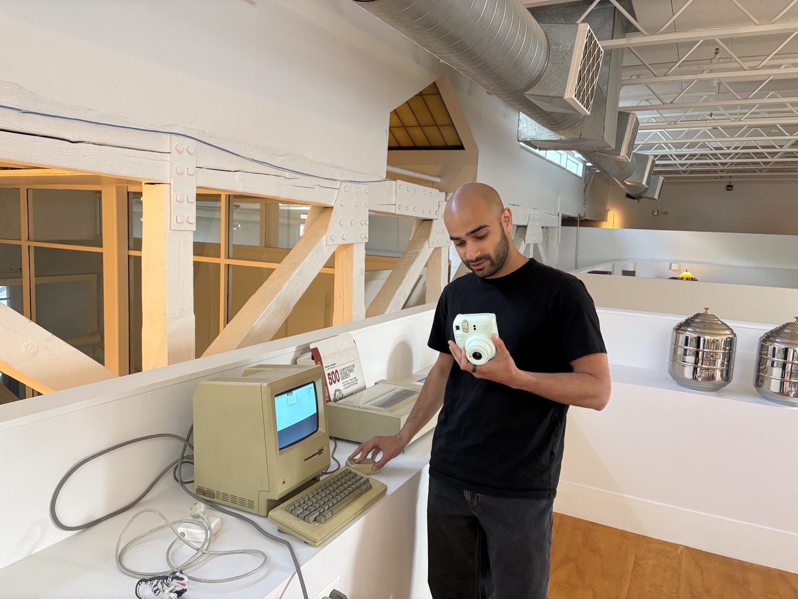 Zubin Koticha with a polaroid camera in the Raindrop office
